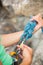 Female rock climber adjusting her harness