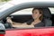 Female rookie new driver young beautiful woman scared and stressed while driving car in fear and shock