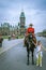 Female Royal Canadian mounted police officer and a little girl holding her horse