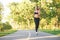 Female runner jogging in the forest