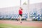 Female runner jogging on stadium track, woman athlete running and working out outdoors, sport and fitness concept. Young woman in