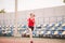 Female runner jogging on stadium track, woman athlete running and working out outdoors, sport and fitness concept. Young woman in