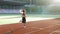 Female runner practicing on athletics race track. Athletic woman running on track stadium at summer morning light. Fit