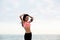 Female runner standing on seashore resting