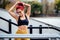 Female runner stretching, preparing for training. Fitness athletic woman warming up for running