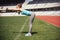 Female runner stretching, preparing for training. Fitness sportswoman warming up for running on track