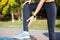 Female runner touching cramped calf at jogging