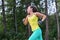 Female runner training outdoor in profile. Healthy lifestyle image of young woman jogging outside.