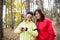 Female runners with smartwatch outdoors in forest in nature, checking the time.