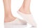 Female\'s feet with white slippers.