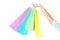 Female\'s hand holding colorful shopping bags