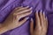 Female\'s hands with gelish manicure and nails of purple color