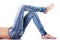 Female\'s legs in jeans on the floor. Side view.