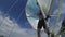 A female sailor changes the Spinnaker on the bow of the yacht.