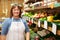 Female Sales Assistant At Vegetable Counter Of Farm Shop