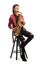 Female saxophonist in a red leather jacket playing sax while sitting on a chair
