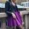 Female scater skirt and leather jacket. Girl wearing fashionable outfit with black leather jacket and purple circle skirt