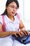 Female scholar typing on laptop in class