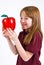 Female school child holding a clear plastic apple