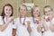 Female School Sports Team In Gym With Medals