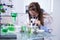 Female scientist adjusting her microscope in a biotechnology lab