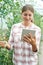 Female Scientist With Digital Tablet In Greenhouse Researching T