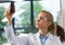 Female Scientist Examine Bottle With Chemicals Working In Modern Laboratory, Attractive Woman Researcher