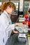 Female scientist examining boiled beaker chemical solution