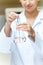 Female scientist shaking a liquid in an erlenmeyer