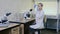 a female scientist studies a test tube with a sample in the laboratory.