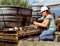 A female scientist takes water samples at an industrial facility