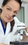 Female Scientist Using Microscope in Laboratory