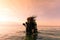 Female Scuba Dive Instructor Wearing a Dry Suit, a Twin Tank and Holding Fins Flipping Wet Hair in the Air