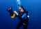 Female scuba diver underwater performing a dexterity exercise