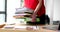 Female secretary manager takes large stack of documents from table