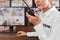 Female security guard with portable transmitter at workplace, closeup