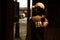 Female security guard walking through an automated revolving curved sliding door to patrol a commercial area