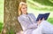 Female self improvement. Girl lean on tree while relax in park sit grass. Self improvement book. Business lady find