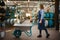 Female seller in apron holds garden cart in shop