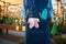 Female seller in apron holds gardening tools