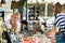 A female seller discussing the price with a customer at an antique street market in Split, Croatia