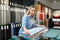 Female seller measures fabric in textile store