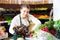 Female seller working with greens and letuce on the supermarket