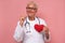 Female senior doctor holding a red heart encouraging a healthy lifestyle