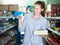 Female in the shop holding preserved of tuna