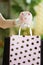 Female shopper with piggy bank, rubber gloves and bags