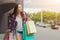 Female shopper walking in city with shopping bags