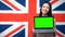 Female showing laptop with green screen against British flag background, study