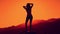Female silhouette dancing at the mountain, beautiful sunset