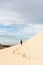 Female silhouette walking in desert sand dunes of Mui Ne, Vietnam